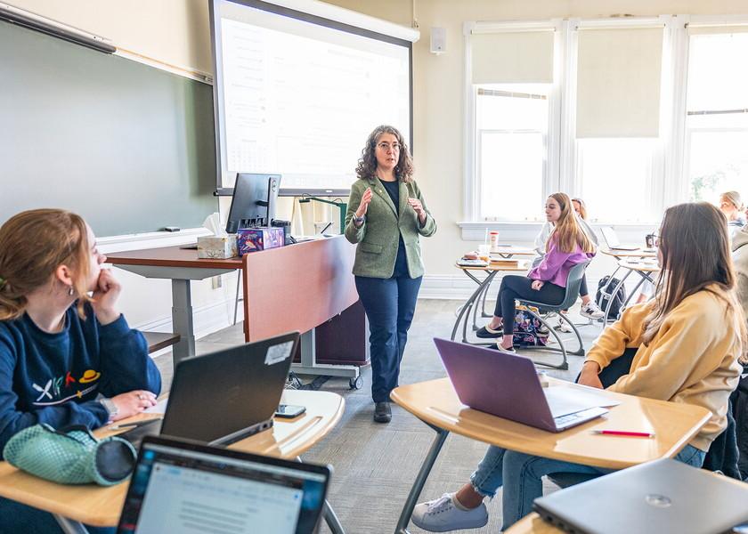 Sarah Kelen teaching in a classroom full of students.